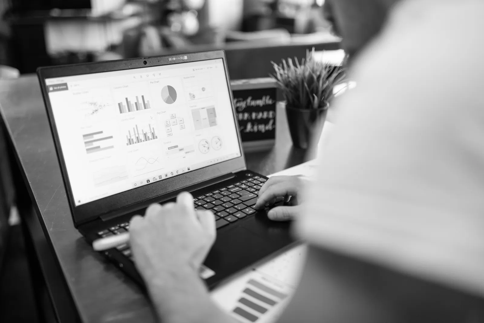 Laptop showing charts and graphs on an office desk
