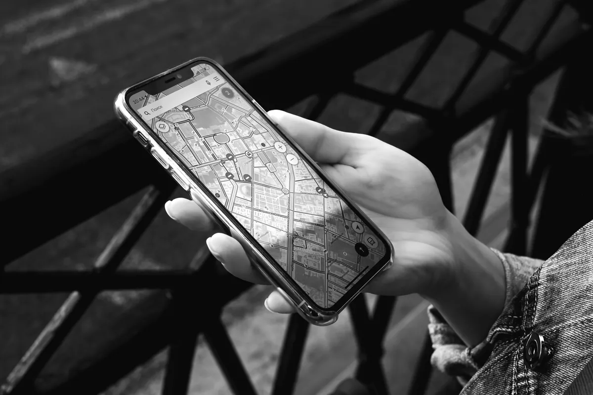 Hand holding a phone showing a street map