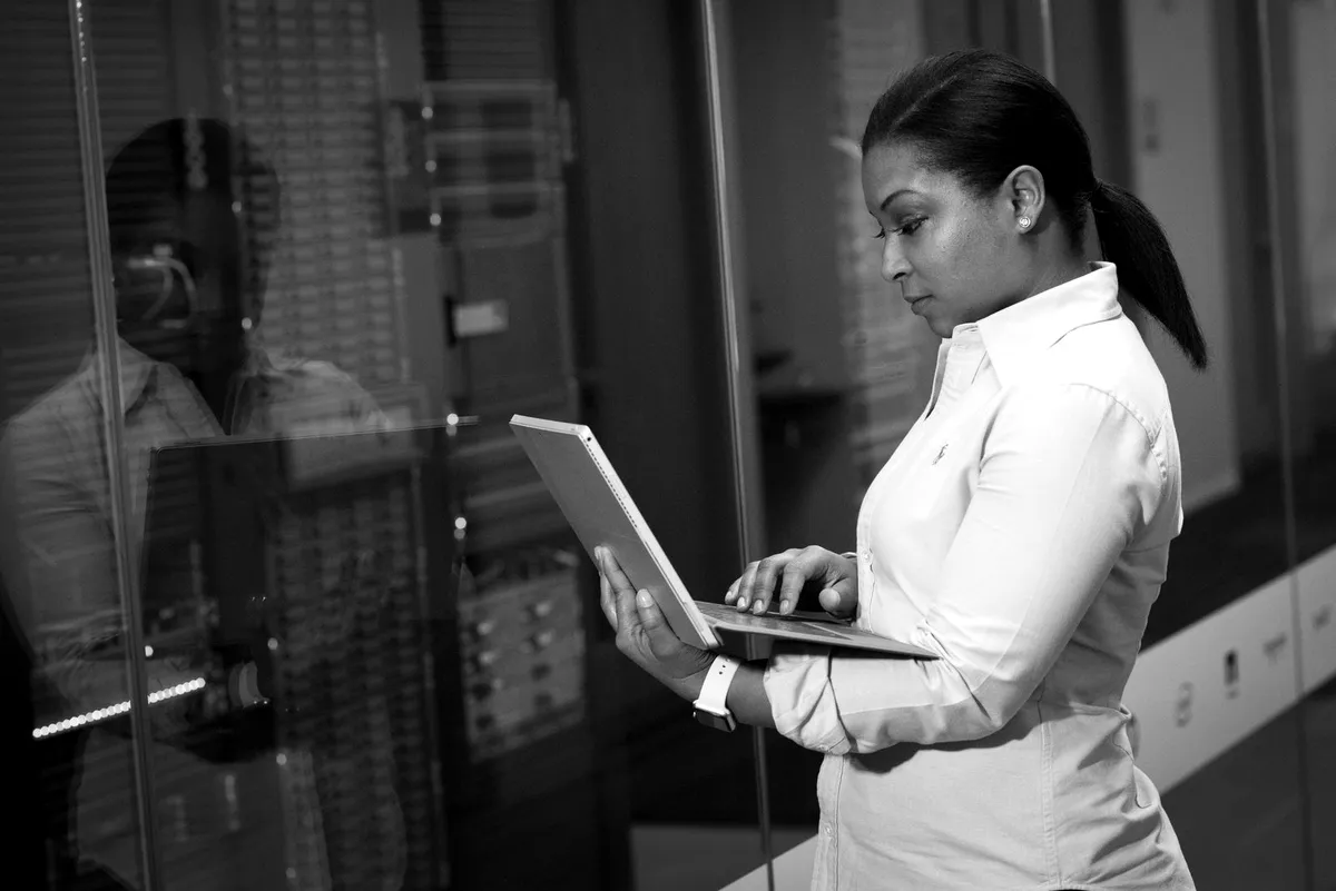 IT engineer working on a laptop in a data center