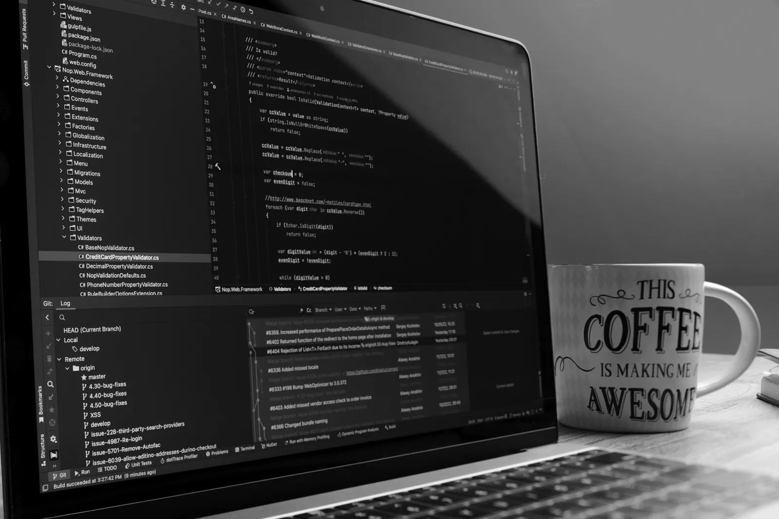 Laptop showing code in an editor next to a coffee mug on a desk