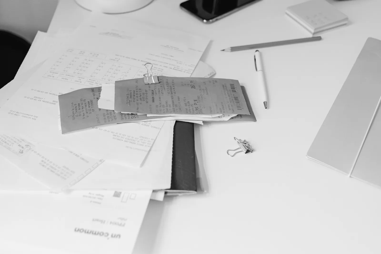 Receipts and documents arranged on a tidy desk