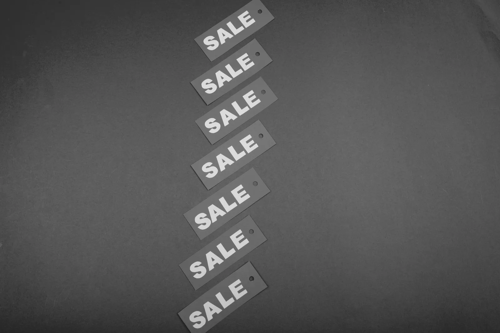 Diagonal row of price tags laid out on a flat surface