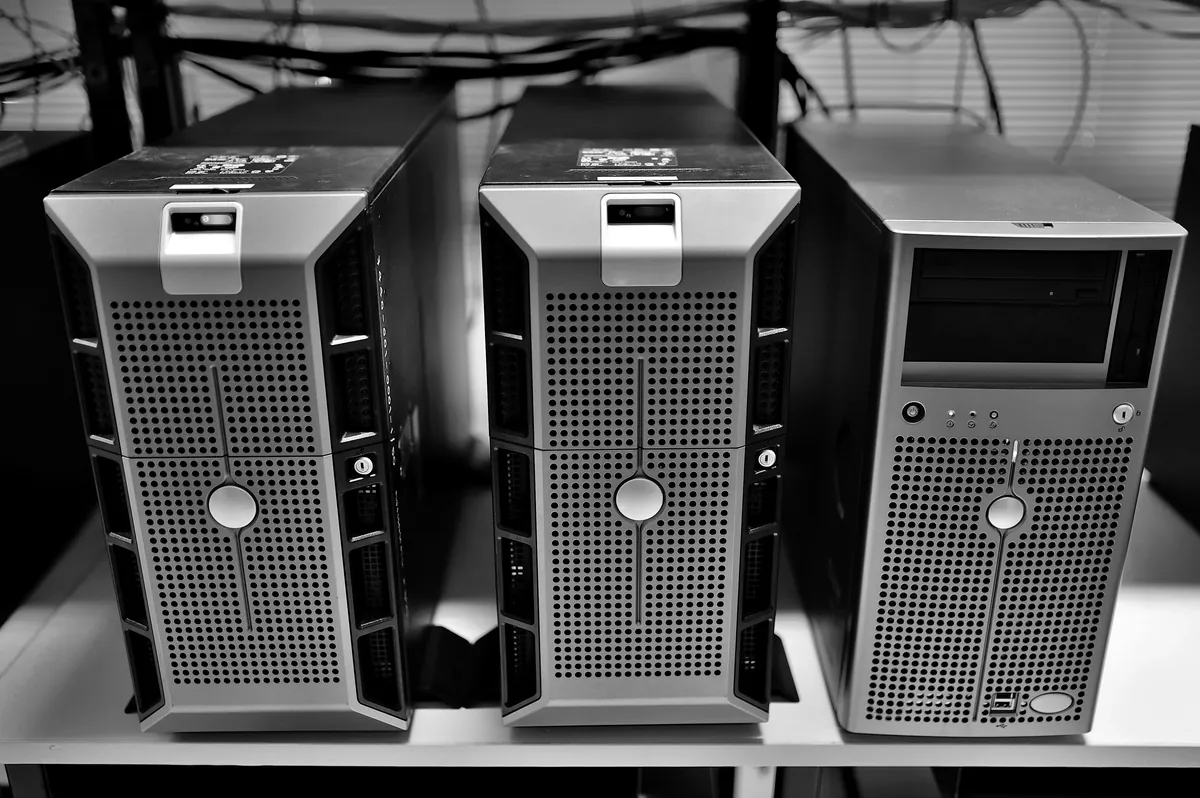 Tower servers lit in blue on a data center shelf